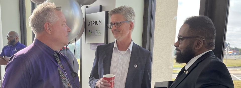 Provost Jenks chatting with other faculty and staff at the Bagels with President event on Macon campus